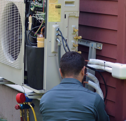ckSmithSuperior technician checking refrigerant connections on AC compressor