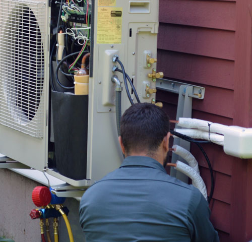 ckSmithSuperior technician checking refrigerant connections on AC compressor
