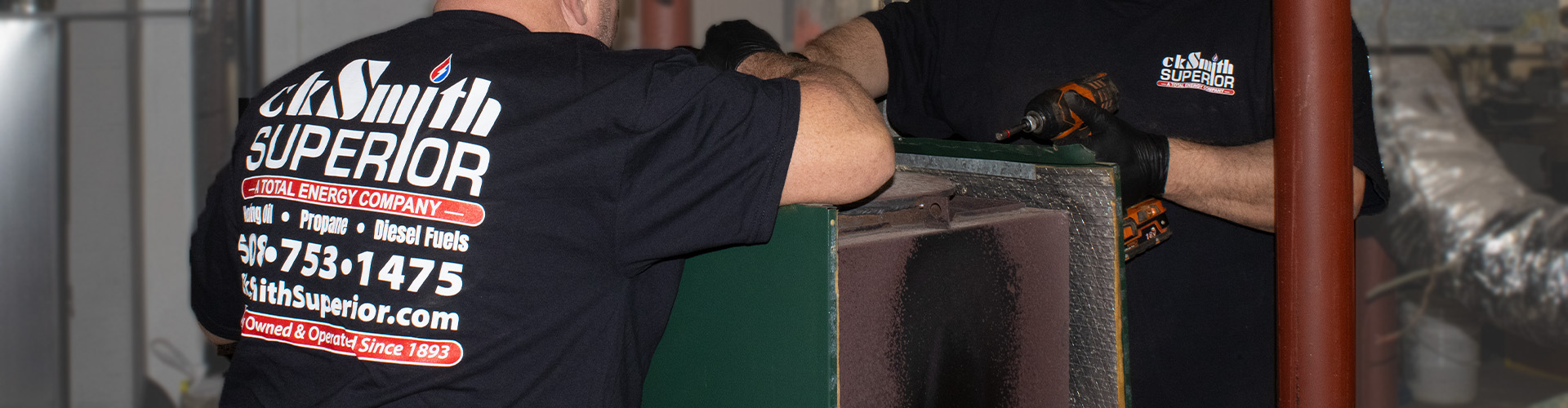 ckSmithSuperior technician performing maintenance on a ductless AC unit